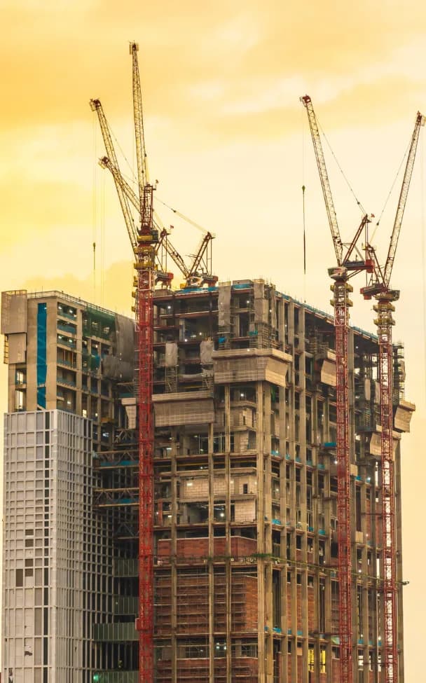 High-rise tower under construction with cranes